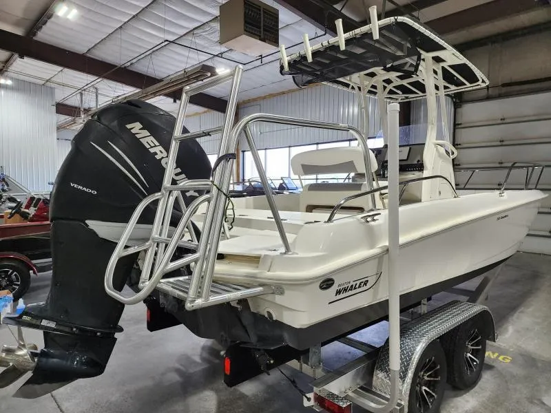 Slide: The Image of 2015 Boston Whaler 240 Dauntless boat with Mercury engine in indoor storage. - 4