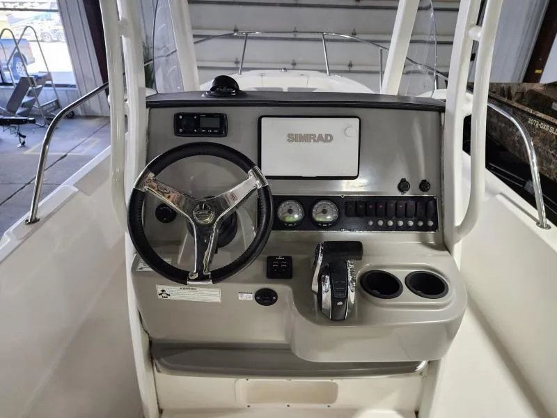 Slide: The Image of 2015 Boston Whaler 240 Dauntless boat console with steering wheel and Simrad display. - 5