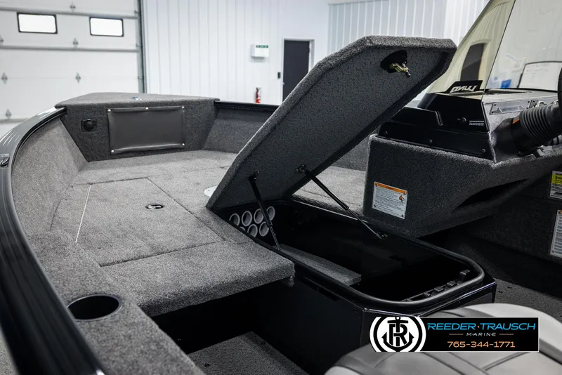 Slide: The Image of 2025 Lund Adventure SS boat interior with open storage compartment in a showroom. - 17