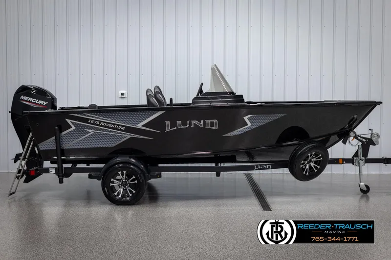 Slide: The Image of 2025 Lund Adventure SS boat with Mercury engine on trailer in showroom. - 3