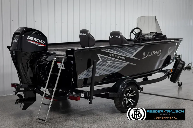 Slide: The Image of 2025 Lund Adventure SS boat with Mercury engine, displayed indoors on a trailer. - 4