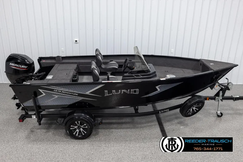 The Image of 2025 Lund Adventure SS boat with Mercury engine on trailer in showroom. - 1