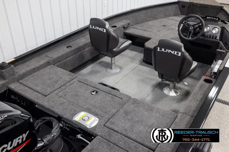 Slide: The Image of 2025 Lund Adventure SS boat interior with two seats and steering console. - 10