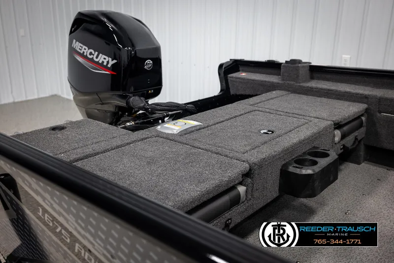 Slide: The Image of 2025 Lund Adventure SS boat interior with Mercury engine, featuring carpeted deck and storage compartments. - 11