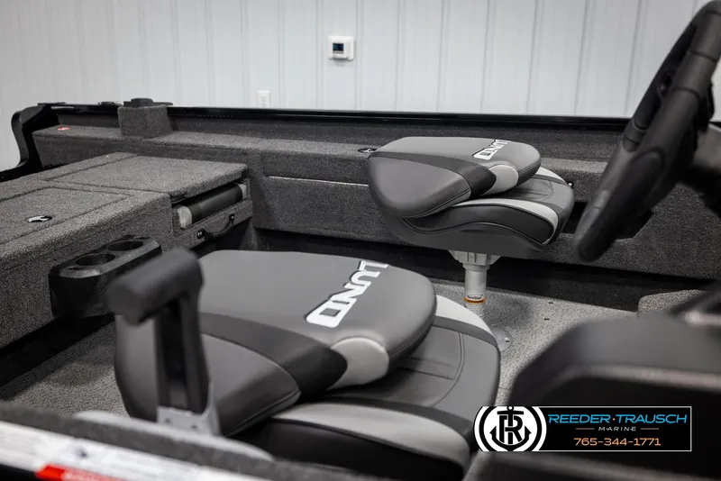 Slide: The Image of 2025 Lund Adventure SS boat interior with gray seating and storage compartments. - 14