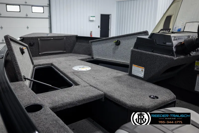 Slide: The Image of 2025 Lund Adventure SS boat interior with storage compartments and control panel. - 16