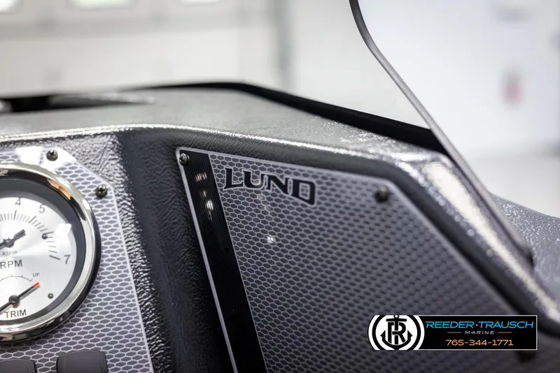 Slide: The Image of Dashboard of 2025 Lund Adventure SS boat with RPM gauge and textured panel. - 25