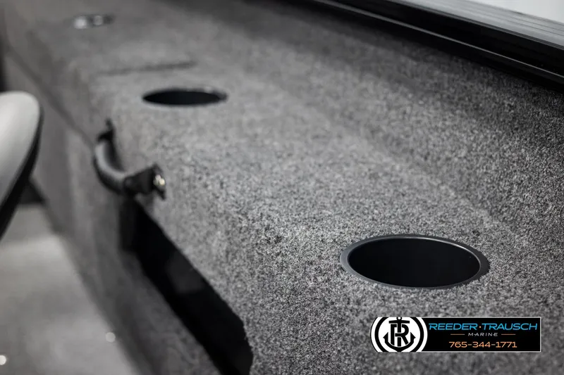 Slide: The Image of 2025 Lund Adventure SS boat interior with cup holders and carpeted surface. - 27