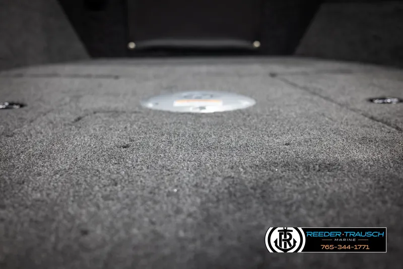 Slide: The Image of 2025 Lund Adventure SS boat interior with carpeted flooring, Reeder-Trausch Marine logo visible. - 29