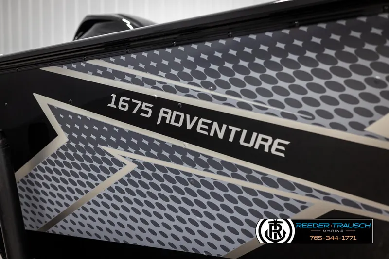 Slide: The Image of 2025 Lund Adventure SS boat with "1675 Adventure" graphic design, Reeder-Trausch Marine logo. - 30