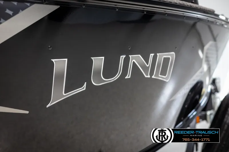 Slide: The Image of 2025 Lund Adventure SS boat with sleek black exterior and bold logo. - 31