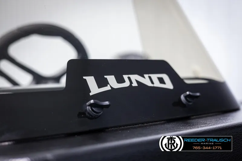 Slide: The Image of 2025 Lund Adventure SS boat dashboard with logo, featuring Reeder-Trausch Marine branding. - 32