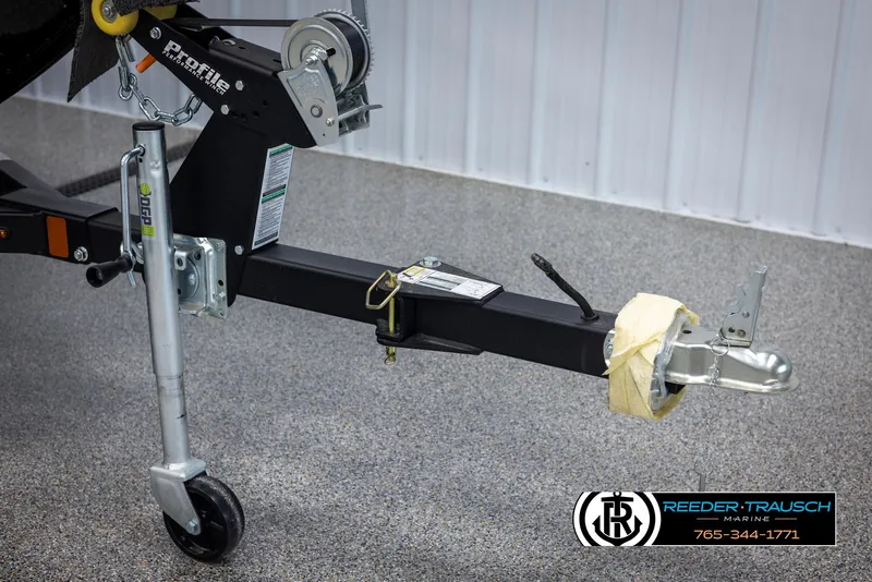 Slide: The Image of Trailer hitch of 2025 Lund Adventure SS boat, featuring a sturdy metal frame and wheel. - 39