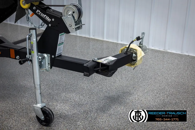 Slide: The Image of 2025 Lund Adventure SS trailer hitch with winch and jack stand in a showroom. - 40