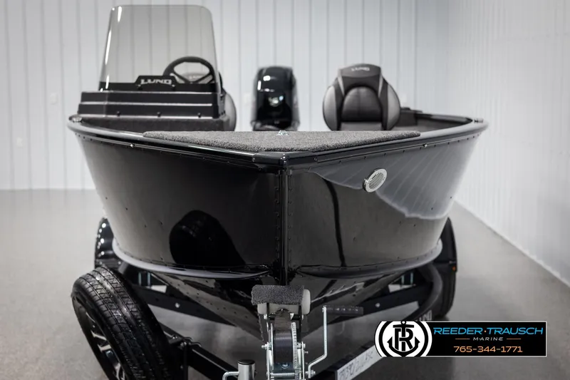 Slide: The Image of 2025 Lund Adventure SS boat in showroom, black exterior, on trailer. - 6