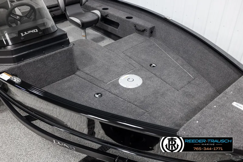 Slide: The Image of 2025 Lund Adventure SS boat interior with gray carpet and seating. - 7