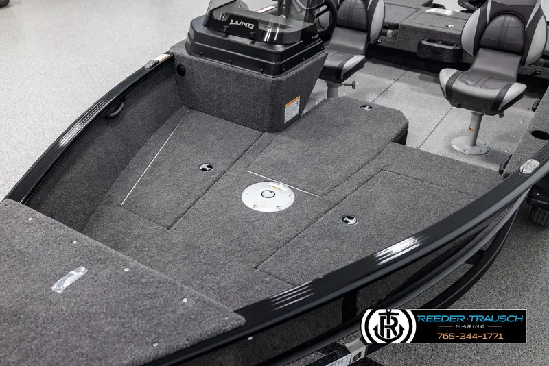 Slide: The Image of 2025 Lund Adventure SS boat interior with gray carpet and seating, showcased by Reeder-Trausch Marine. - 8