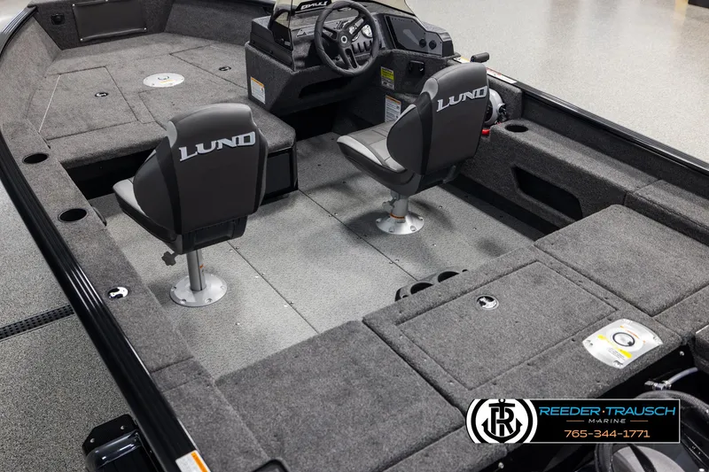Slide: The Image of 2025 Lund Adventure SS boat interior with two seats and steering console. - 9