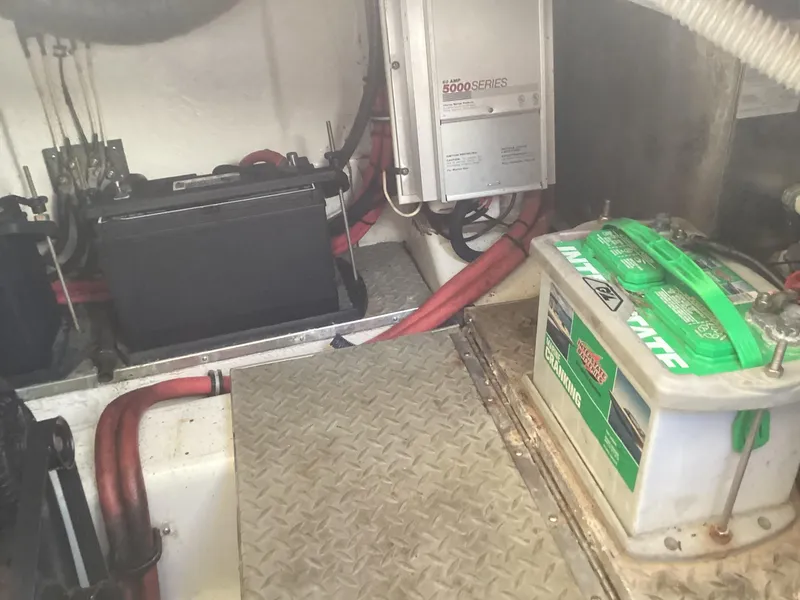 Slide: The Image of Engine compartment of a 2001 Formula 370 Super Sport with batteries and wiring. - 12