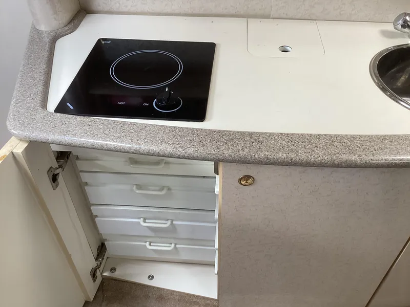 Slide: The Image of 2001 Formula 370 Super Sport kitchen with stove, sink, and storage drawers. - 22