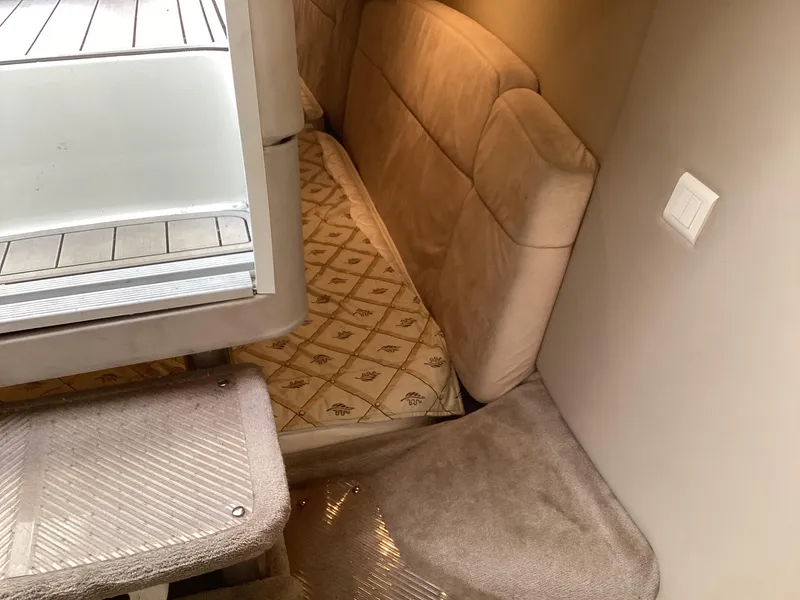 Slide: The Image of Interior cabin of 2001 Formula 370 Super Sport with beige upholstery and patterned bedding. - 25