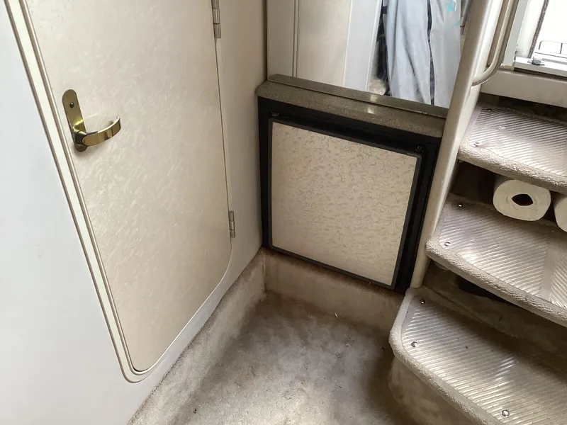 Slide: The Image of Interior of 2001 Formula 370 Super Sport boat, featuring stairs and a door. - 26