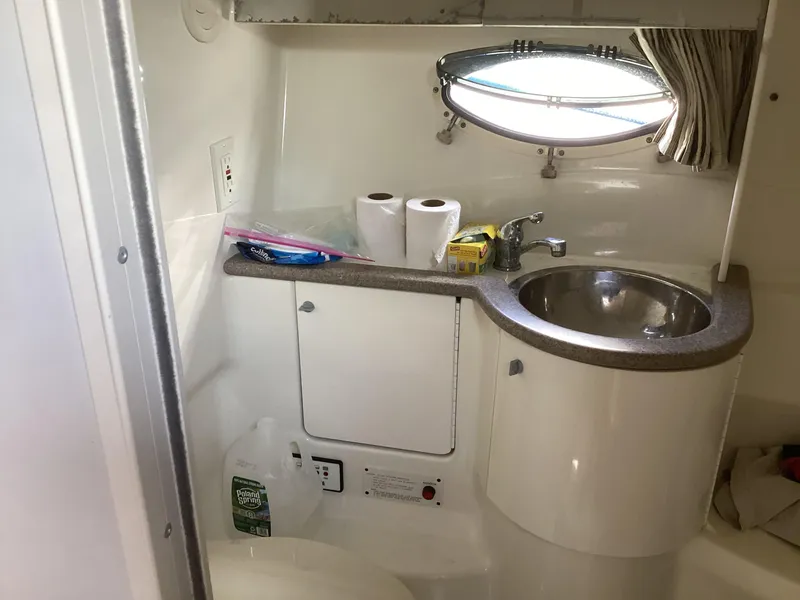 Slide: The Image of 2001 Formula 370 Super Sport boat bathroom with sink, porthole, and toiletries. - 27