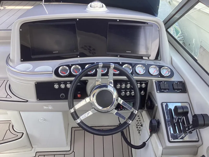 Slide: The Image of 2001 Formula 370 Super Sport boat dashboard with steering wheel and control panels. - 3