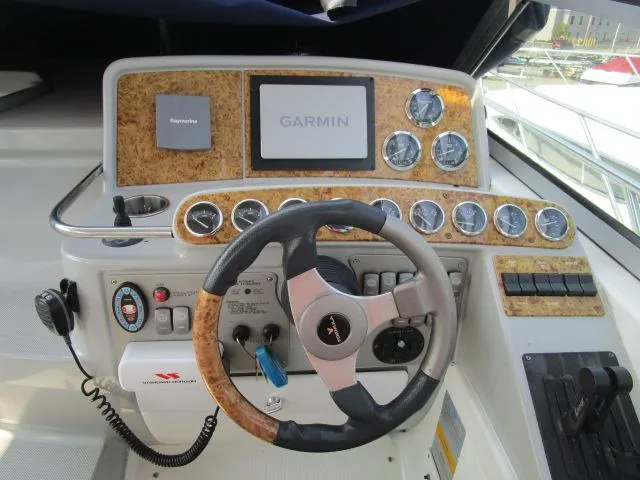 Slide: The Image of 2006 Formula 34 PC boat dashboard with Garmin navigation system and steering wheel. - 15
