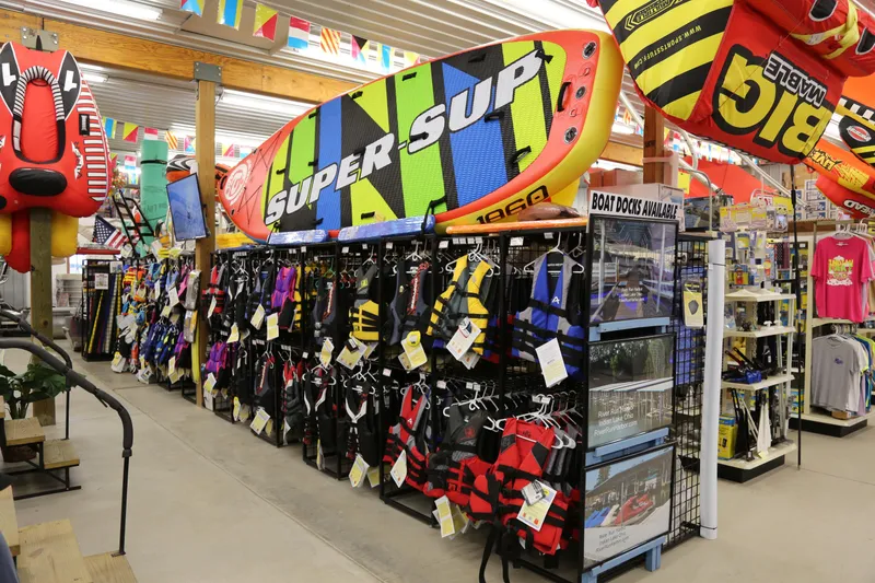Slide: The Image of Water sports store with colorful life jackets and inflatable boards, featuring Barletta Aria 24UC 2025. - 16