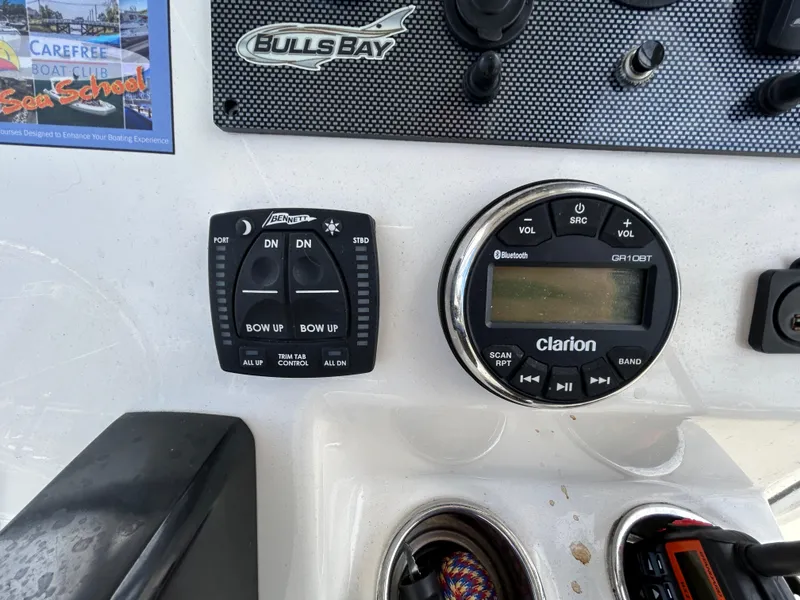 Slide: The Image of Bulls Bay 230 Center Console 2021 dashboard with controls and Clarion audio system. - 11