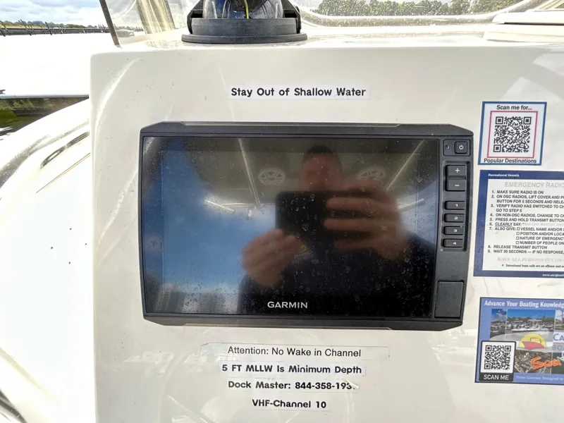 Slide: The Image of Garmin display on 2021 Bulls Bay 230 Center Console boat dashboard with safety instructions. - 12