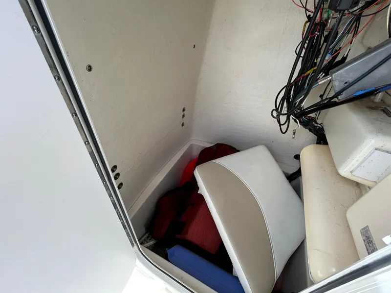 Slide: The Image of Interior storage of 2021 Bulls Bay 230 Center Console boat with cushions and wiring. - 18