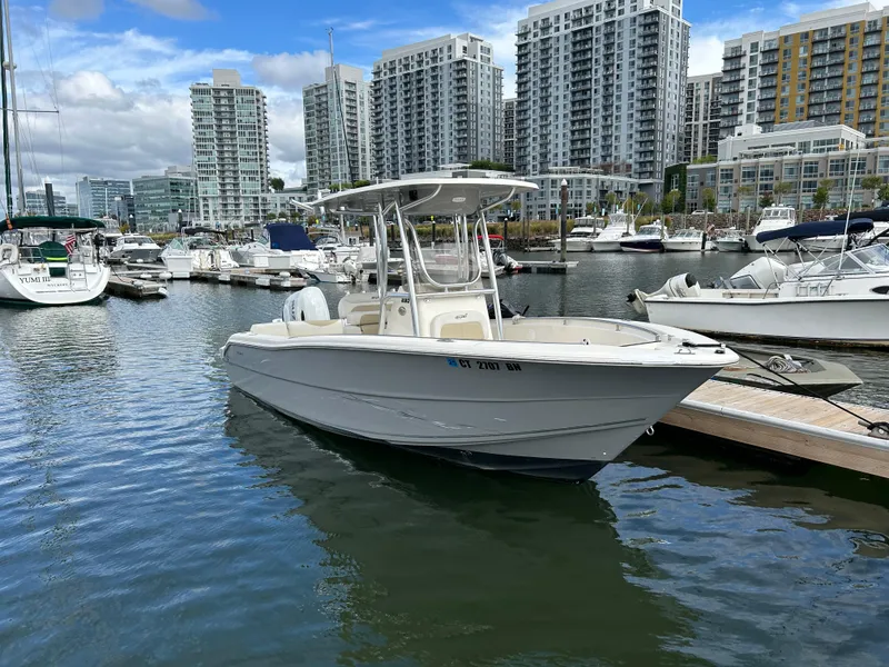 Slide: The Image of 2021 Bulls Bay 230 Center Console boat docked in urban marina. - 2