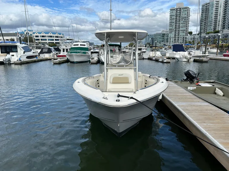 Slide: The Image of 2021 Bulls Bay 230 Center Console boat docked in a marina with surrounding yachts. - 4