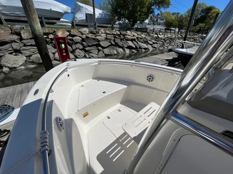 Slide: The Image of 2021 Bulls Bay 230 Center Console boat docked near rocky shoreline. - 5