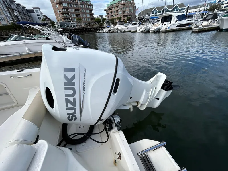 Slide: The Image of Bulls Bay 230 Center Console 2021 with Suzuki outboard motor docked in marina. - 6