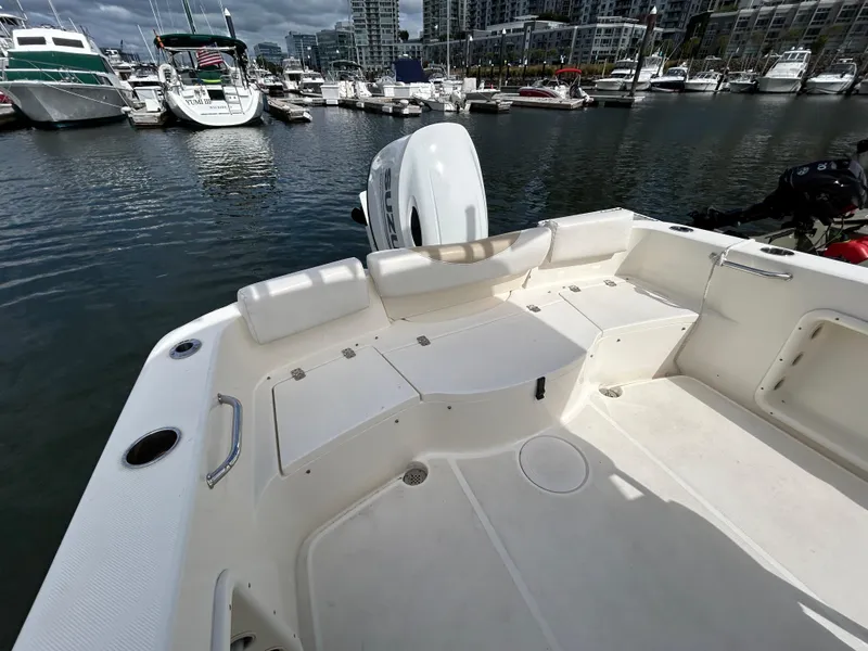 Slide: The Image of 2021 Bulls Bay 230 Center Console boat docked in a marina with other vessels. - 8