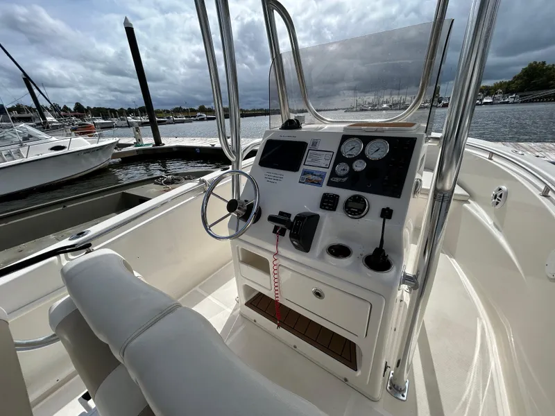 Slide: The Image of 2021 Bulls Bay 230 Center Console boat interior with steering wheel and control panel. - 9