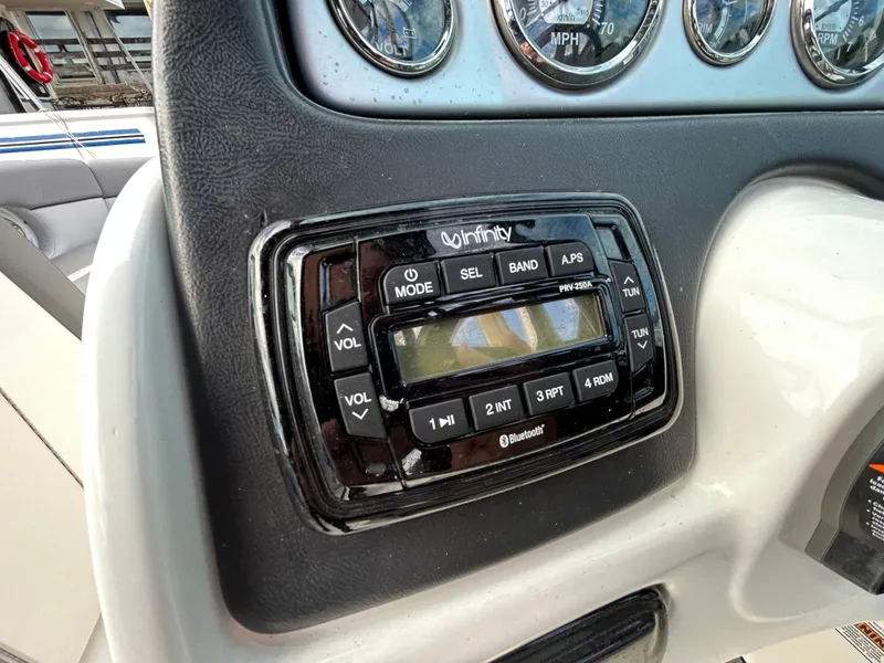 Slide: The Image of Infinity stereo system on 2021 NauticStar 243 DC boat dashboard. - 12