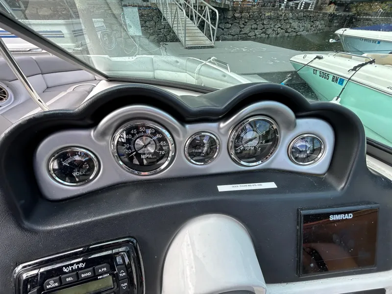 Slide: The Image of Dashboard of 2021 NauticStar 243 DC boat with gauges and Simrad display. - 13