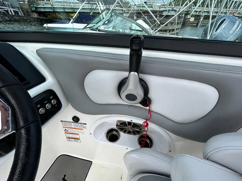 Slide: The Image of 2021 NauticStar 243 DC boat interior with control panel and seating. - 15