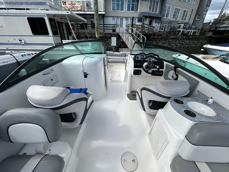 Slide: The Image of 2021 NauticStar 243 DC boat interior with seating, steering console, and cup holders. - 20