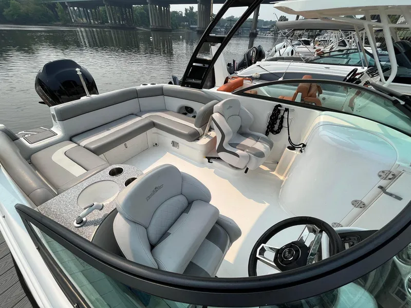 Slide: The Image of 2021 NauticStar 243 DC boat interior with plush seating and modern helm. - 7