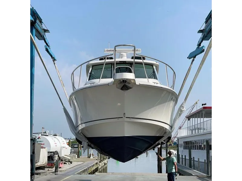 Slide: The Image of 2017 Boston Whaler 345 Conquest boat in dry dock, front view. - 10