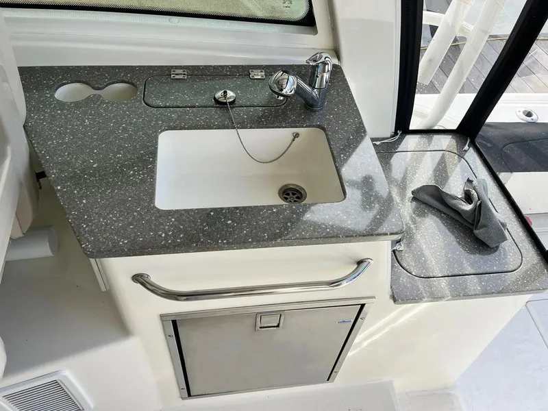 Slide: The Image of Boston Whaler 345 Conquest 2017 boat kitchenette with sink and countertop. - 15