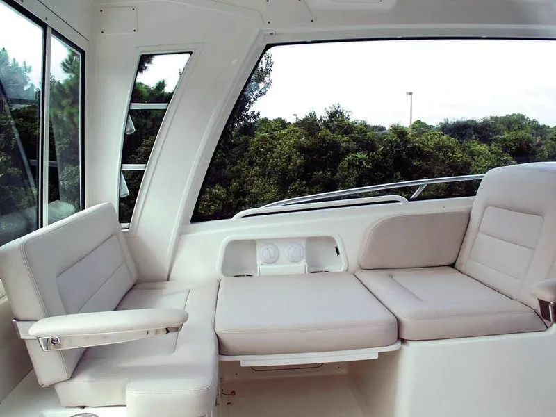 Slide: The Image of Interior seating of 2017 Boston Whaler 345 Conquest boat, featuring plush white cushions. - 16