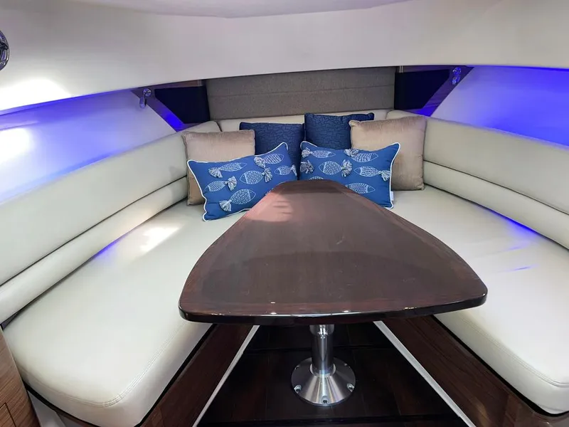 Slide: The Image of 2017 Boston Whaler 345 Conquest cabin with plush seating and decorative pillows. - 21