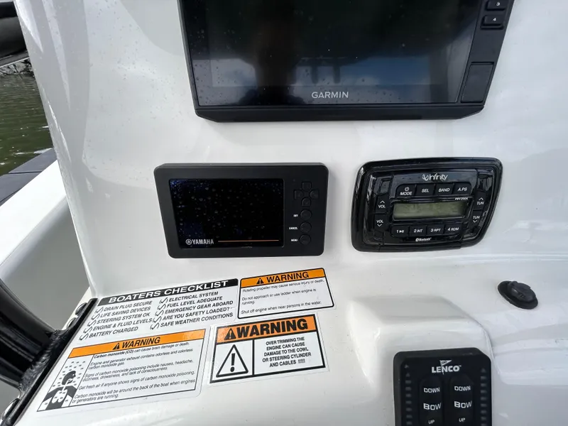 Slide: The Image of Control panel of 2021 NauticStar 2302 Legacy boat with Garmin and Yamaha displays. - 10