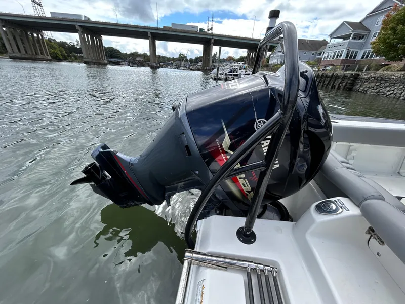 Slide: The Image of 2021 NauticStar 2302 Legacy boat with outboard motor on a calm river. - 6